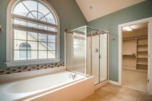 white bathtub near white framed glass window