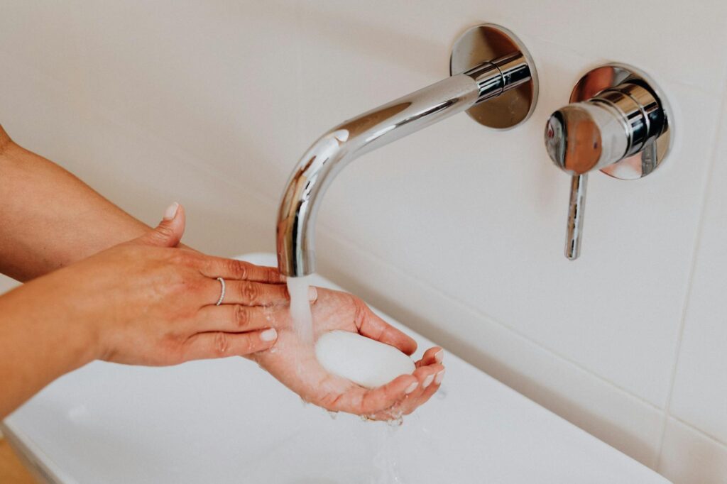 woman washing hands with soap