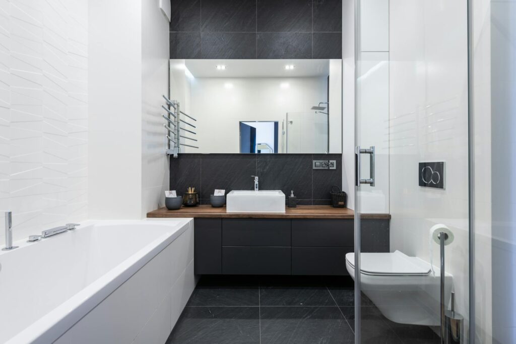 stylish bathroom with bathtub and shower cabin